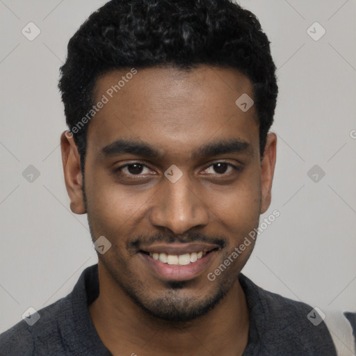 Joyful black young-adult male with short  black hair and brown eyes