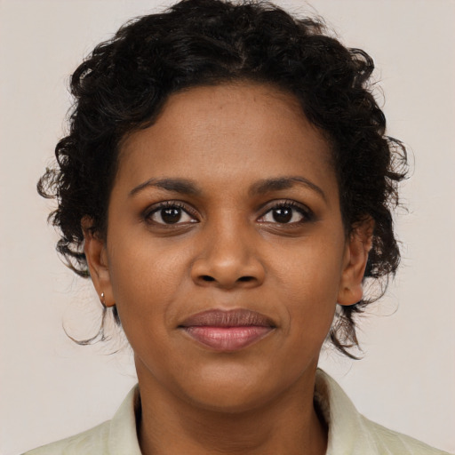 Joyful black young-adult female with medium  brown hair and brown eyes