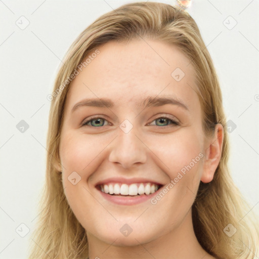 Joyful white young-adult female with long  brown hair and blue eyes