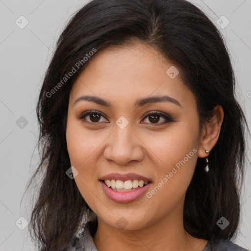 Joyful latino young-adult female with long  brown hair and brown eyes