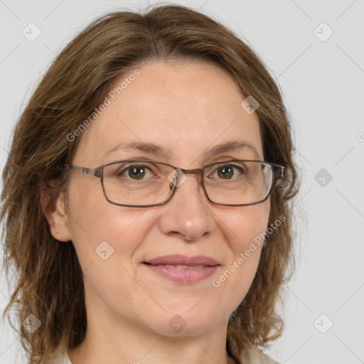 Joyful white adult female with medium  brown hair and green eyes