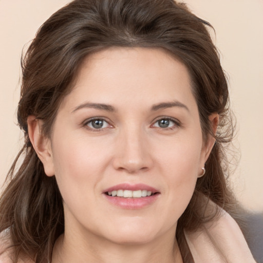 Joyful white young-adult female with medium  brown hair and brown eyes