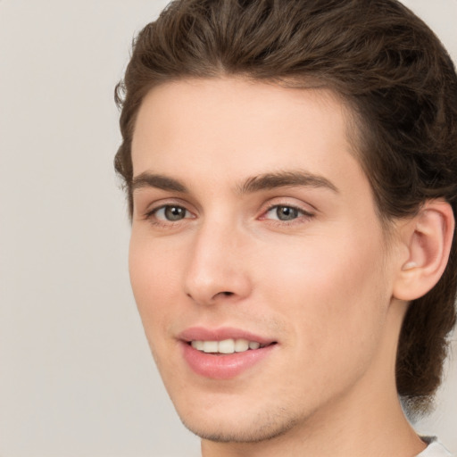 Joyful white young-adult male with medium  brown hair and brown eyes