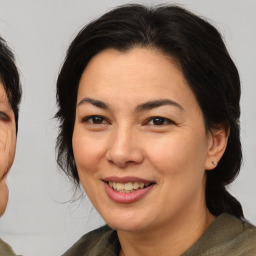 Joyful asian adult female with medium  brown hair and brown eyes