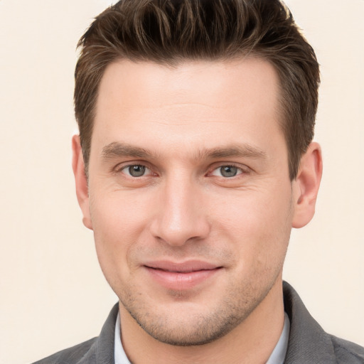 Joyful white young-adult male with short  brown hair and brown eyes