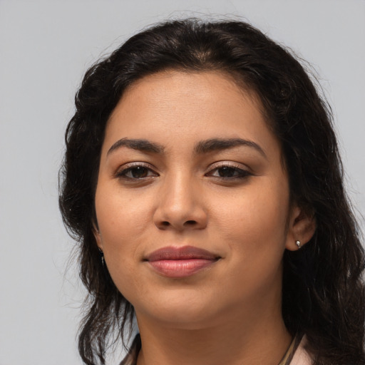 Joyful latino young-adult female with long  brown hair and brown eyes