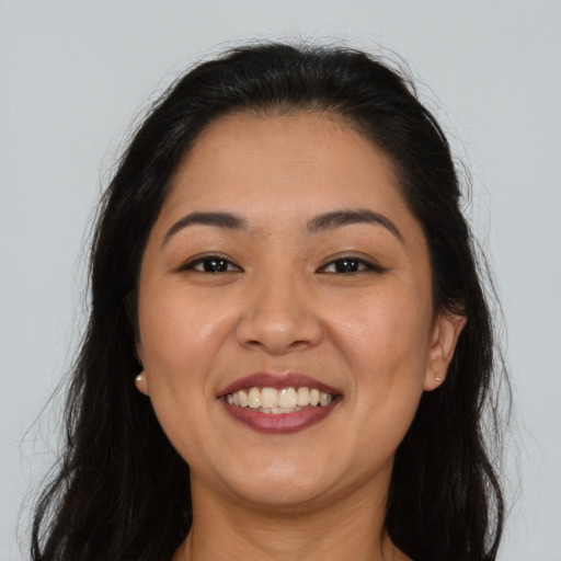 Joyful asian young-adult female with long  brown hair and brown eyes