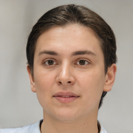 Joyful white young-adult female with short  brown hair and brown eyes