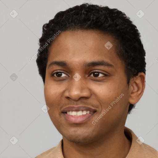 Joyful black young-adult male with short  black hair and brown eyes