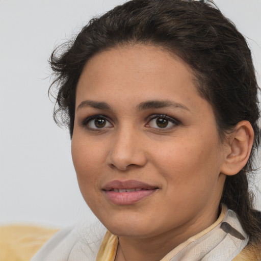 Joyful latino young-adult female with medium  brown hair and brown eyes
