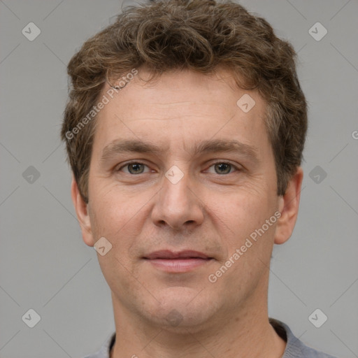 Joyful white adult male with short  brown hair and grey eyes