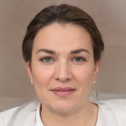 Joyful white adult female with medium  brown hair and brown eyes