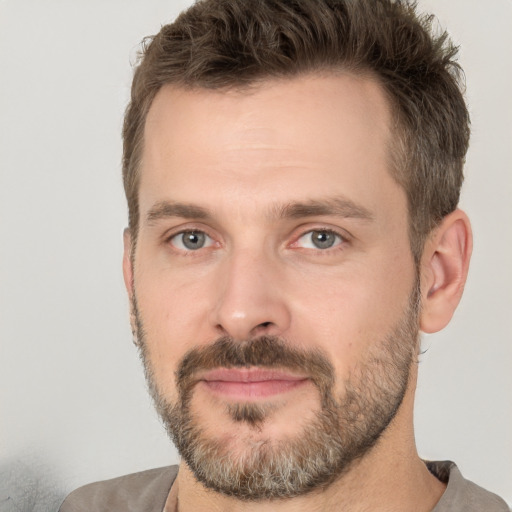 Joyful white adult male with short  brown hair and brown eyes