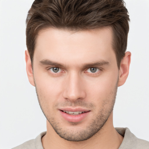 Joyful white young-adult male with short  brown hair and brown eyes