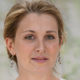 Joyful white young-adult female with medium  brown hair and green eyes