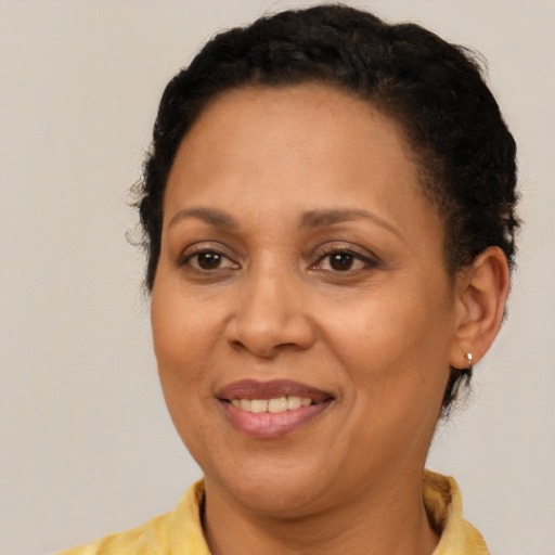 Joyful latino adult female with short  brown hair and brown eyes