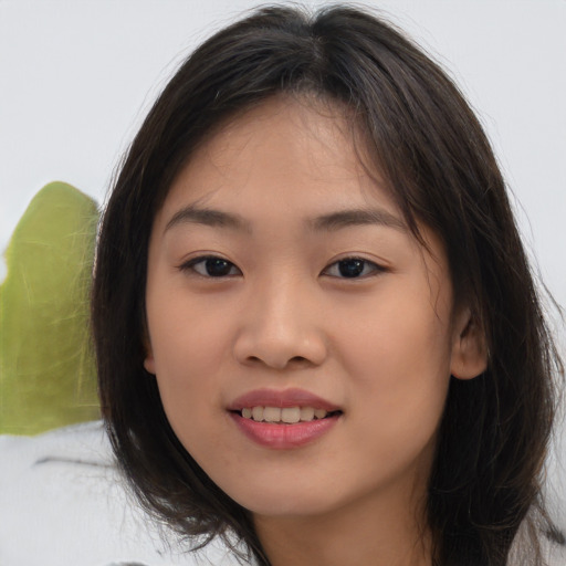 Joyful asian child female with medium  brown hair and brown eyes