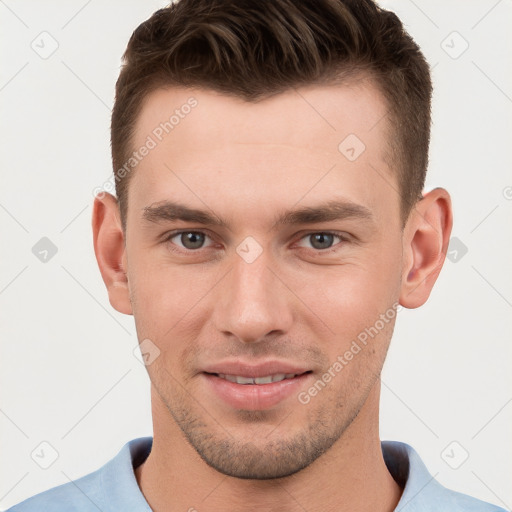 Joyful white young-adult male with short  brown hair and grey eyes