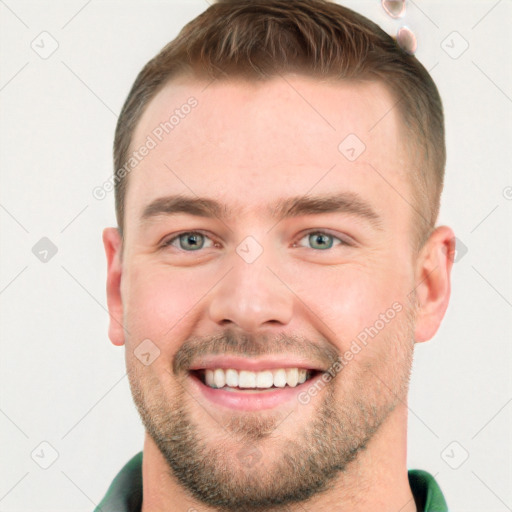 Joyful white young-adult male with short  brown hair and grey eyes