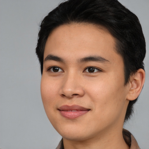 Joyful asian young-adult male with medium  black hair and brown eyes