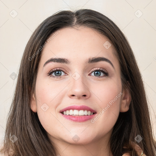 Joyful white young-adult female with long  brown hair and grey eyes