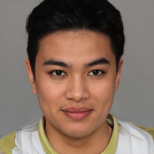 Joyful latino young-adult male with short  black hair and brown eyes