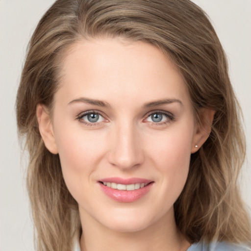 Joyful white young-adult female with long  brown hair and grey eyes