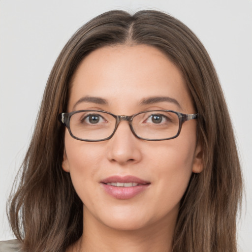 Joyful white young-adult female with long  brown hair and grey eyes