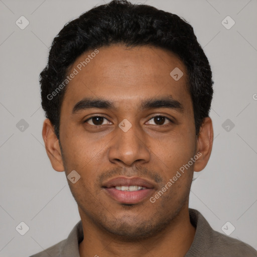 Joyful black young-adult male with short  black hair and brown eyes