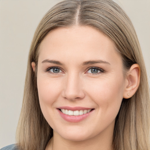 Joyful white young-adult female with long  brown hair and grey eyes