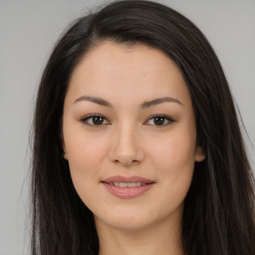 Joyful asian young-adult female with long  brown hair and brown eyes