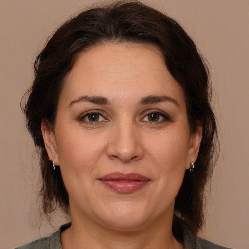 Joyful white adult female with medium  brown hair and brown eyes