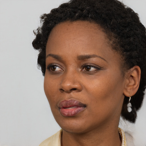 Neutral black young-adult female with short  black hair and brown eyes