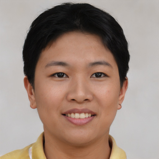 Joyful asian young-adult female with short  black hair and brown eyes
