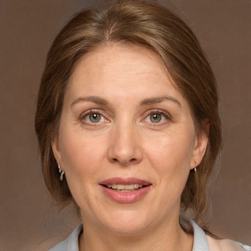 Joyful white adult female with medium  brown hair and brown eyes