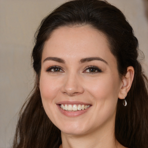 Joyful white young-adult female with long  brown hair and brown eyes