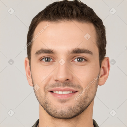 Joyful white young-adult male with short  brown hair and grey eyes