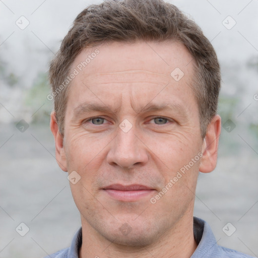 Joyful white adult male with short  brown hair and grey eyes