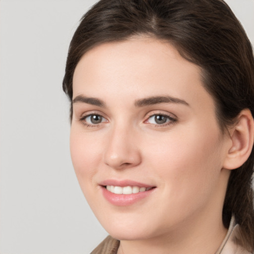 Joyful white young-adult female with medium  brown hair and brown eyes