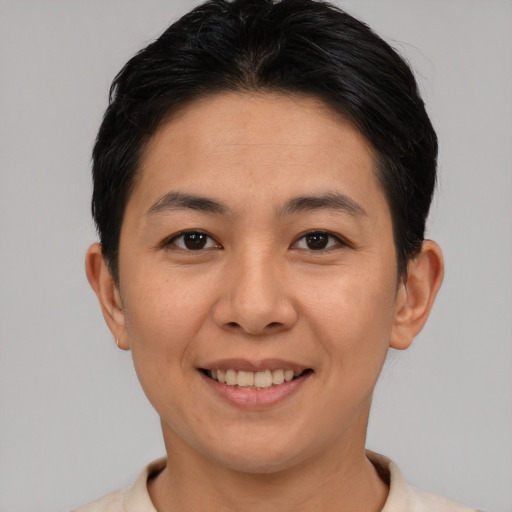 Joyful asian young-adult female with short  black hair and brown eyes