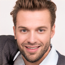 Joyful white young-adult male with short  brown hair and brown eyes