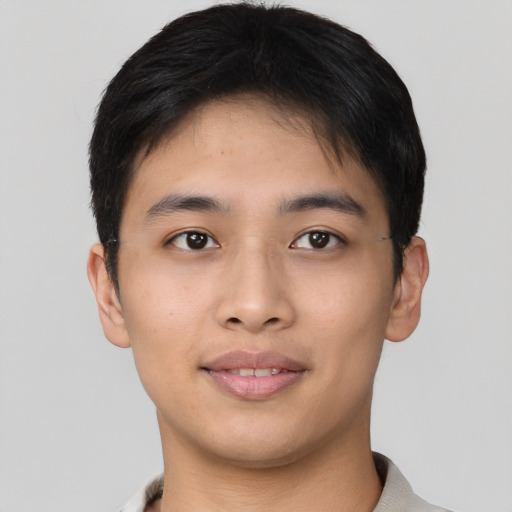 Joyful asian young-adult male with short  brown hair and brown eyes