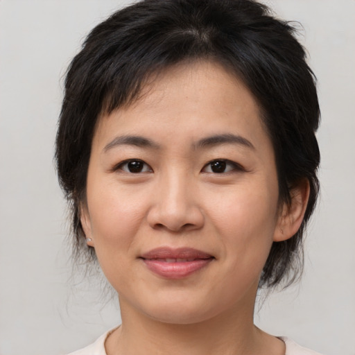 Joyful asian young-adult female with medium  brown hair and brown eyes