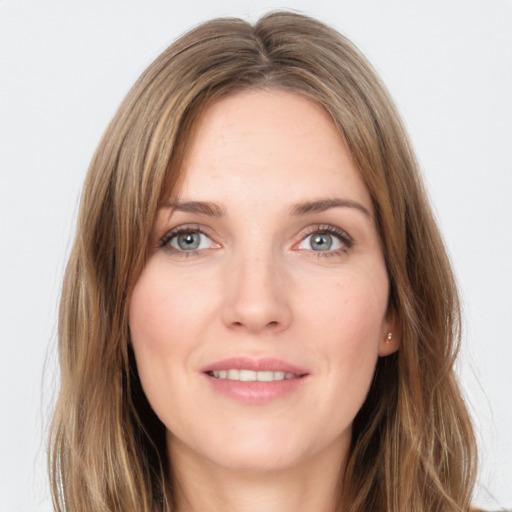 Joyful white young-adult female with long  brown hair and grey eyes