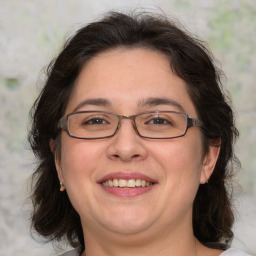 Joyful white adult female with medium  brown hair and brown eyes