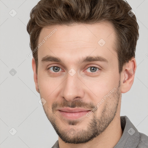 Joyful white young-adult male with short  brown hair and grey eyes