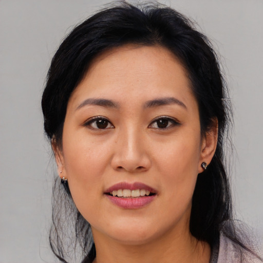 Joyful asian young-adult female with medium  black hair and brown eyes