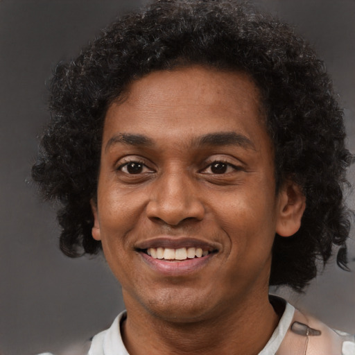Joyful black young-adult male with short  black hair and brown eyes