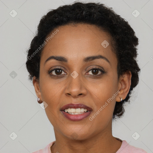 Joyful black young-adult female with short  black hair and brown eyes