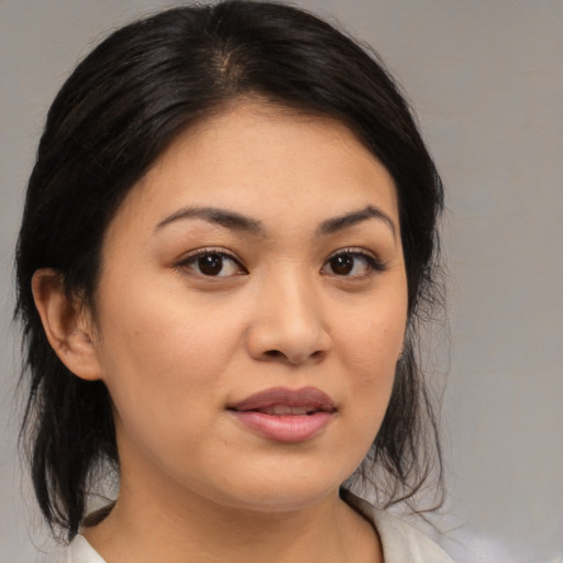 Joyful asian young-adult female with medium  brown hair and brown eyes